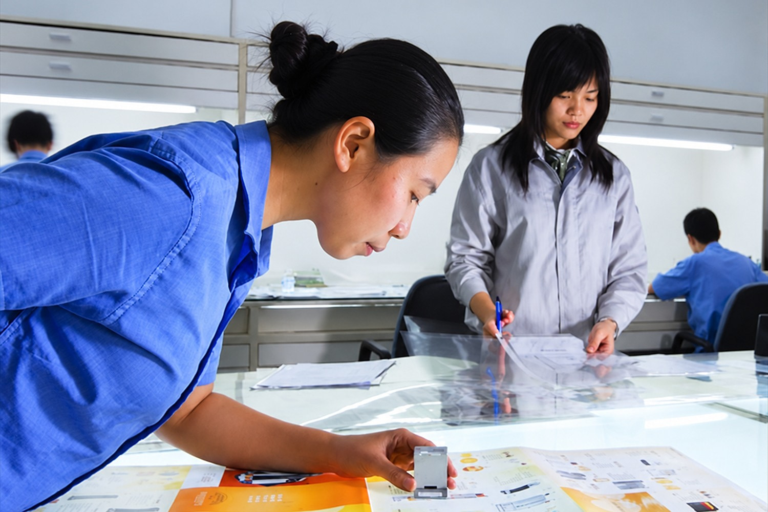 Production team reviewing printed colour proofs